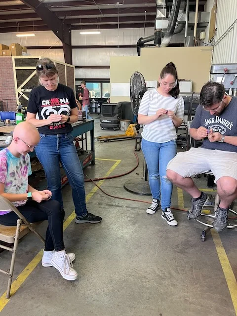 A group working on small handwork projects together at Kilroy’s Workshop.